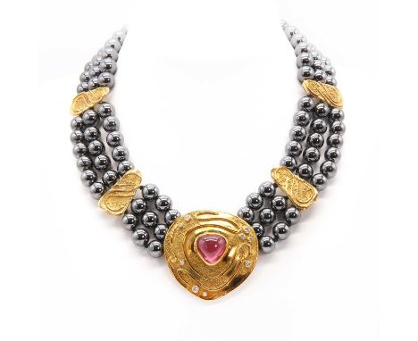 A pink tourmaline and diamond three row haematite necklace, by Elizabeth Gage, c.1990, with a pear shaped centrepiece. A pear