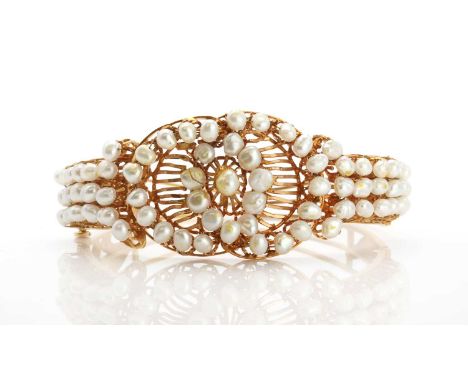 A cultured freshwater pearl hinged bangle, with a raised cultured freshwater pearl to the centre, a centrepiece composed of t