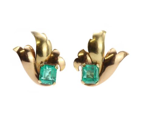 A pair of emerald earrings, c.1940, each designed as a three part wing or leaf, with a rectangular emerald cut emerald claw s