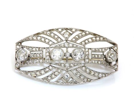A French diamond set plaque brooch/pendant, c.1920-1925,of pierced curved tonneau form. A pair of old European cut diamonds, 