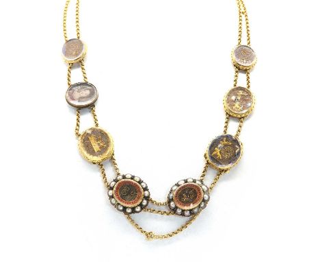 A necklace composed of nine 17th and 18th century ‘Stuart crystal’ memorial slides, with two rows of belcher link chain to a 