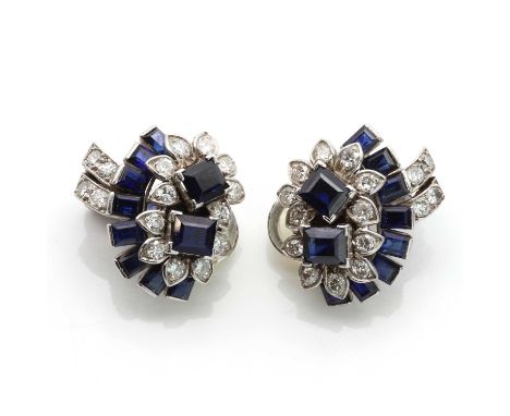 A pair of sapphire and diamond spray style clip earrings,with a pair of flower heads with trap cut sapphires, set with cover 