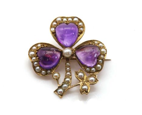 A late Victorian amethyst and split pearl shamrock brooch, c.1900,with a heart shaped cabochon amethyst, set to each leaf. A 