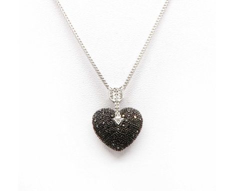 An 18ct white gold black and colourless diamond heart and arrow pendant and chain, c.2003,a puffed heart, pavé set with brill