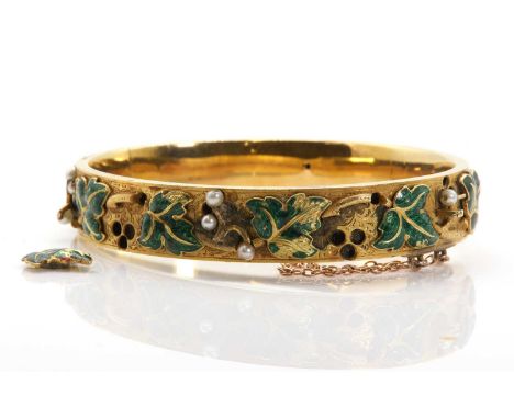 A Russian enamel and seed pearl gold hinged bangle, c.1848,a flat section hollow bangle, 10.70mm wide, with applied ivy leave