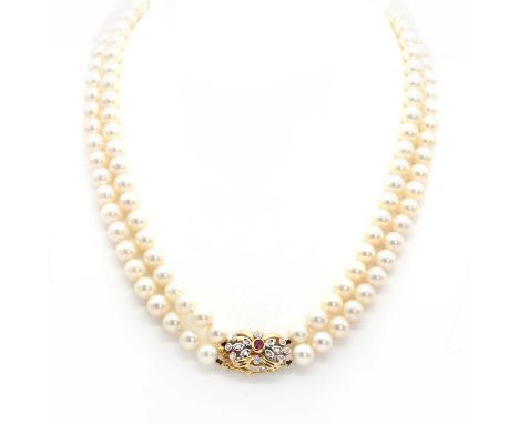 A two row uniform cultured pearl necklace,with a ruby and diamond clasp. Two rows of uniform cultured pearls 6.50mm to 7.00mm