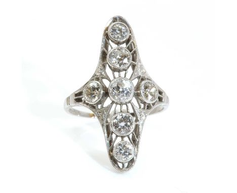 An American or Canadian Art Deco diamond set fingerline ring, c.1920,with seven open cut diamonds, milligrain set in plain co