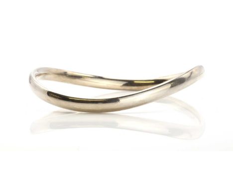 A sterling silver slave bangle by Georg Jensen, designed by Astrid Fog no. 237A, of oval elliptical form, with an asymmetrica