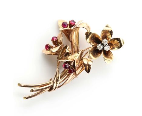 A three colour gold diamond and ruby spray brooch, c.1940,with a trefoil cluster of old European cut and old Swiss cut diamon