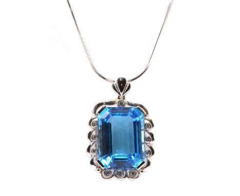 A Continental blue topaz and diamond pendant and earring matched suite,the pendant composed of an emerald cut blue topaz, cla