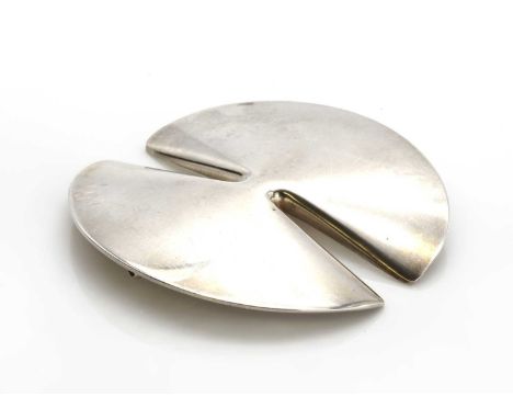 A sterling silver brooch by Georg Jensen, designed by Nanna Ditzel no. 337A, of circular disc form, with two incurved slits, 