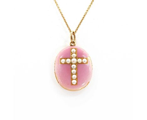 An Edwardian oval photo locket, with a split pearl Latin cross to a pink guilloche enamel ground. Glazed locket verso, suspen