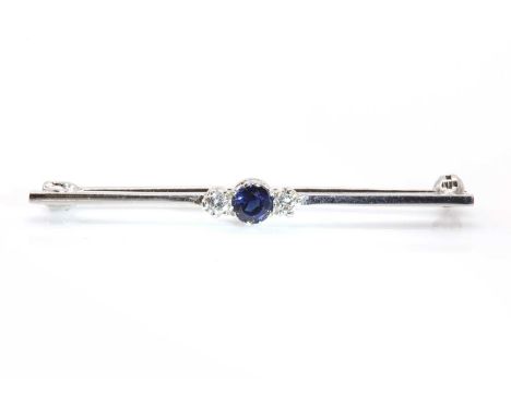 An 18ct white gold three stone sapphire and diamond bar brooch, by Cropp &amp; Farr,with a circular mixed cut sapphire, claw 