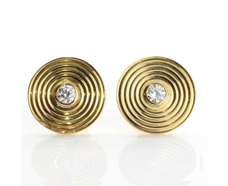 A pair of 18ct gold diamond set disc style earrings, c.1980,with a brilliant cut diamond, rub set to a flat section disc, wit
