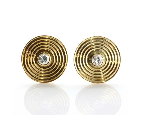 A pair of 18ct gold diamond set disc style earrings, c.1980,with a brilliant cut diamond, rub set to a flat section disc, wit