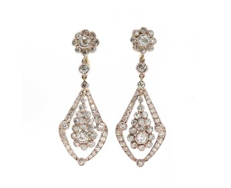 A pair of diamond cluster drop earrings,with a kite shaped diamond set frame below. The daisy cluster top composed of an old 