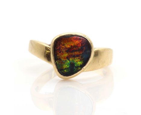 A single stone freeform boulder opal ring,with a flat cabochon boulder opal, rub set in a plain collet. A slightly wishbone t