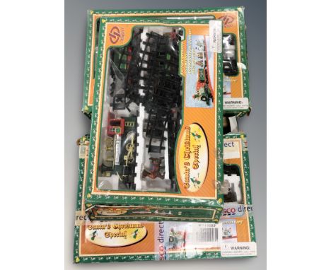 Three Christmas themed model train sets. (packaging as found)