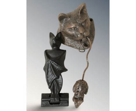 A cast metal door knocker in the form of a cat holding a mouse, length 23 cm, and another in the form of a bat.