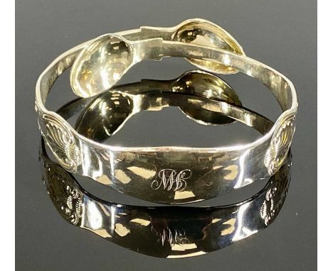 UNUSUAL SILVER BANGLE, formed from Victorian silver sugar nips, London 1865Provenance: private collection Denbighshire