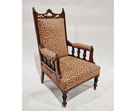 Victorian mahogany armchair with leopard print upholstery, on turned supports and castors&nbsp;