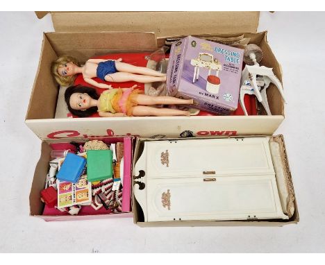 Three Sindy dolls (one missing a leg) together with a large collection of clothes, Sindy's own car, Sindy's Bedside Table and