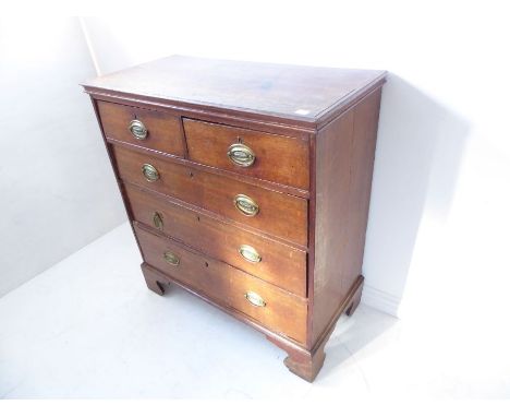 A late 18th century oak chest; the slightly overhanging moulded top above two half-width and three full-width graduated drawe