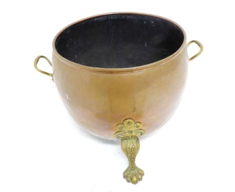An early 20th century cauldron-type copper and brass coal bucket; twin-handled and with tripod paw-style feet (37.5cm diamete
