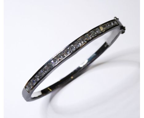 A silver bangle set with hand-cut cubic zirconia-style stones (boxed)