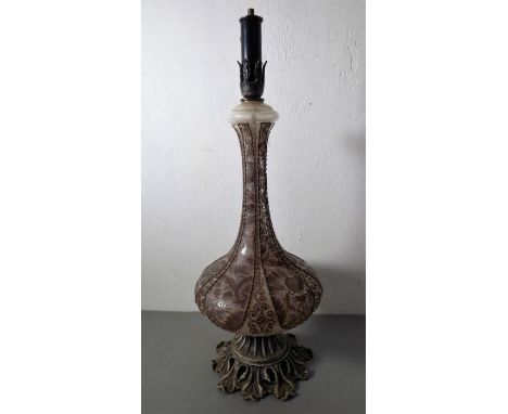 A highly ornate bottle vase-shaped table lamp; the elongated tubelined-style neck above squat ovoid body and a cast base in f