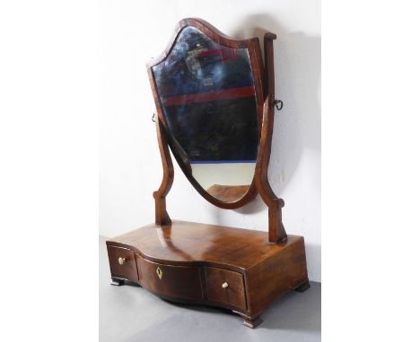 A late 18th century mahogany and rosewood crossbanded toilet mirror; the shield-shaped plate above central bow-fronted drawer