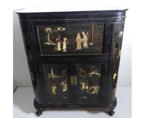 An early 20th century Japanned period cocktail cabinet for restoration; the hinged lid with rounded corners opening to reveal