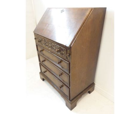 A good reproduction oak writing bureau in the 18th century-style. The cleated angular fall opening to reveal fitted interior 