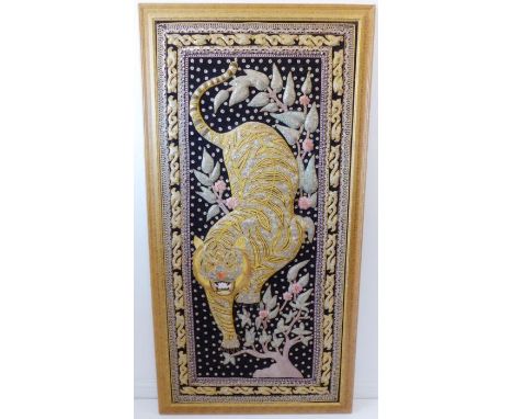 A large and fine needlework. Advancing tiger slinking through flowerheads and foliage. Gold-coloured wire and multi-coloured 