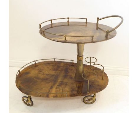 An original two-tier oval brass-mounted drinks trolley on spoked wheels (approx. 79cm long x 69cm highest point to top of han