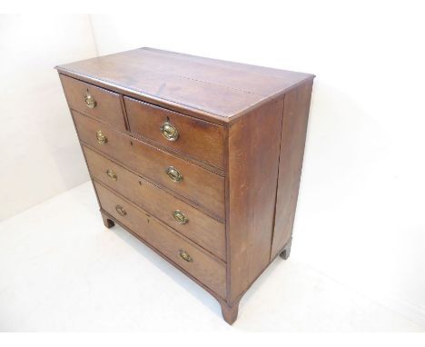 A late 18th century oak and mahogany crossbanded chest; the moulded top above two half-width and three full-width graduated d