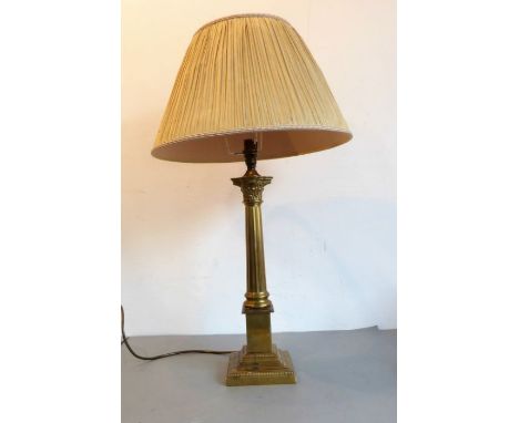 A Laura Ashley brass table lamp modelled as a Corinthian column with acanthus capital, together with shade