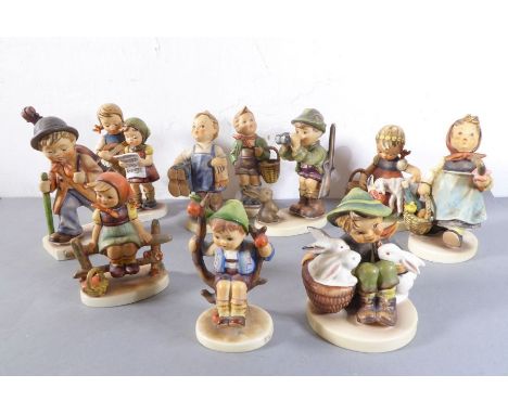 Ten various Goebel (Germany) hand-decorated porcelain figures; the largest of a young boy with a double bass upon his back (1