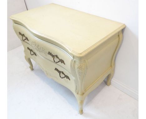 A antiqued painted Louis XV-style serpentine-fronted commode; moulded top above two full width drawers with cast handles in h