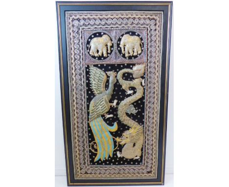 A hand-stitched wall-hanging needlework depicting a four-clawed scaly dragon and an exotic bird; two opposing elephants above