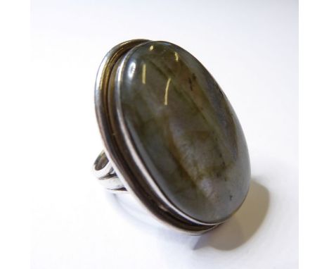 A lady's silver dress ring centrally set with a large polished cabochon hardstone resembling labradorite, ring size K (boxed)