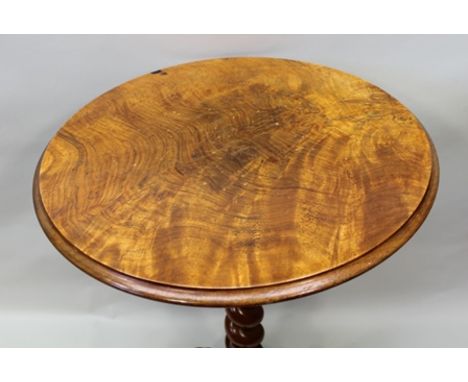 A VICTORIAN WALNUT TOP WINE TABLE, raised on barley twist stem, tripod supports with carved scroll toes, 48cm diameter at top