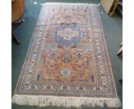 A MID 20TH CENTURY SOUTH CAUCASIAN WOVEN WOOL FLOOR CARPET having many geometric forms, stylised desert plants and animals, i