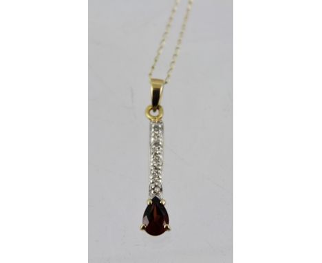 A RUBY AND DIAMOND PENDANT, fashioned as a bar with single pear cut stone and small diamond bar, on a gold coloured metal cha