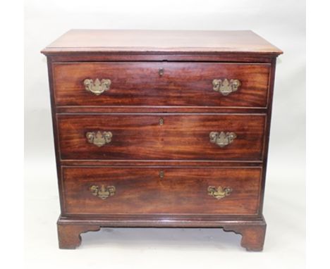 A GEORGE III MAHOGANY CHEST OF THREE LONG DRAWERS with brass swan neck handles with shaped plate backs, raised on bracket fee