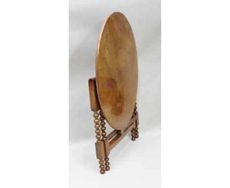 A MID VICTORIAN WALNUT AND MAHOGANY OCCASIONAL TABLE, having folding oval top, supported on bobbin turned and blocked base, t