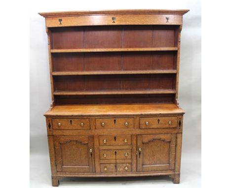 A 19TH CENTURY OAK DRESSER, with plate rack back, the base fitted with inline three drawers over central bank of three drawer