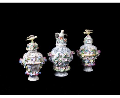 A pair of Bow porcelain 'frill' vases, circa 1765, typically modelled and decorated, the covers surmounted with a bird finial
