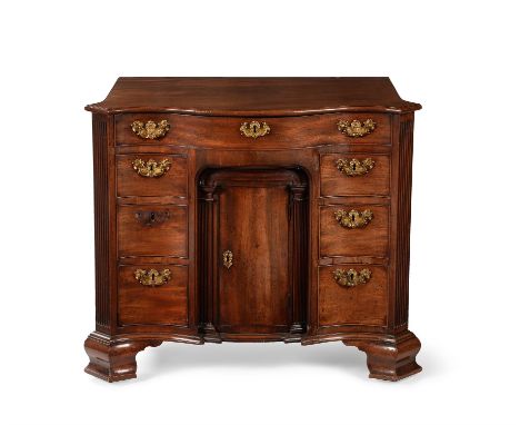 A George II mahogany serpentine fronted, combined gentleman's desk and dressing table, circa 1755, the hinged top opening to 