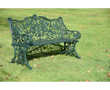 A Victorian green painted garden bench, possibly Coalbrookdale, late 19th century, the shaped back- and armrests with scrolle